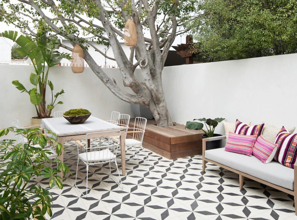 Wooden deck surrounded by vibrant flowers in bohemian backyard ideas